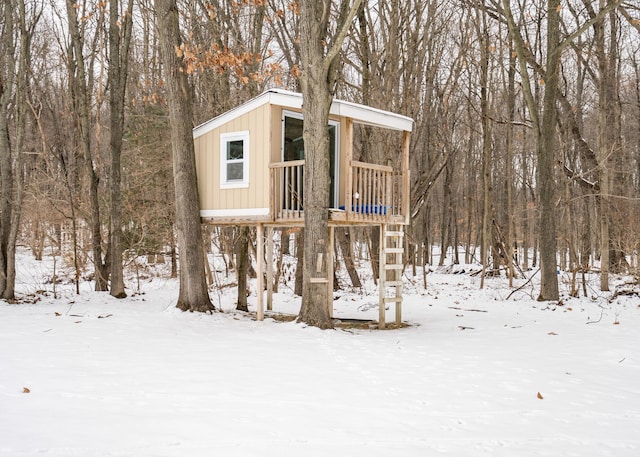 snow covered structure featuring a playground