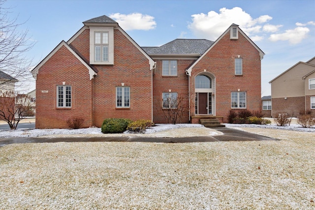 traditional home featuring brick siding