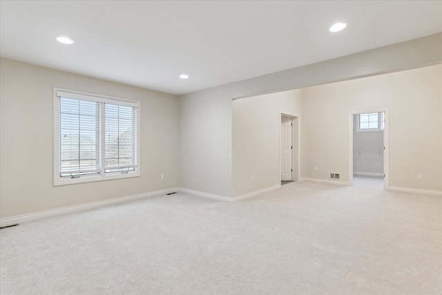 empty room with baseboards, light carpet, and recessed lighting