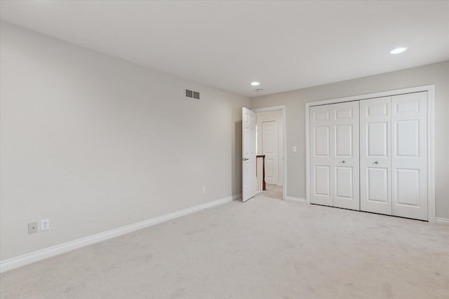 unfurnished bedroom featuring light carpet, baseboards, and visible vents