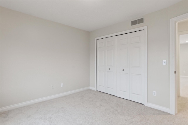 unfurnished bedroom featuring baseboards, visible vents, and carpet flooring