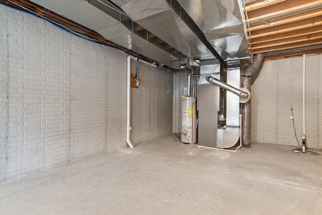 unfinished below grade area featuring heating unit, brick wall, and gas water heater