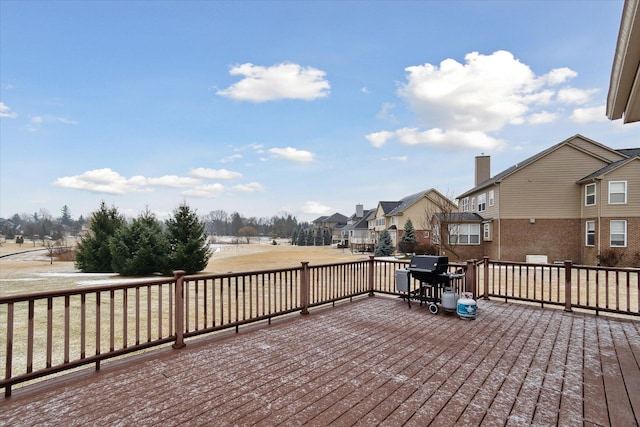 deck with area for grilling and a residential view