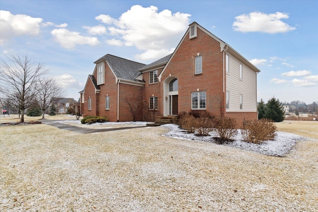 view of front of house featuring brick siding