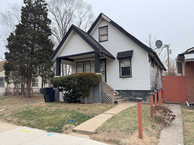 bungalow-style house with a front yard