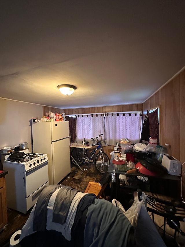 interior space with wood walls and white appliances