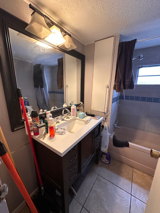 bathroom featuring tile patterned floors, vanity, shower / bathing tub combination, and a textured ceiling