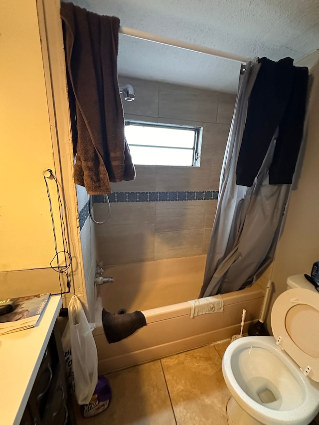 bathroom featuring tile patterned flooring, shower / bathtub combination with curtain, and toilet