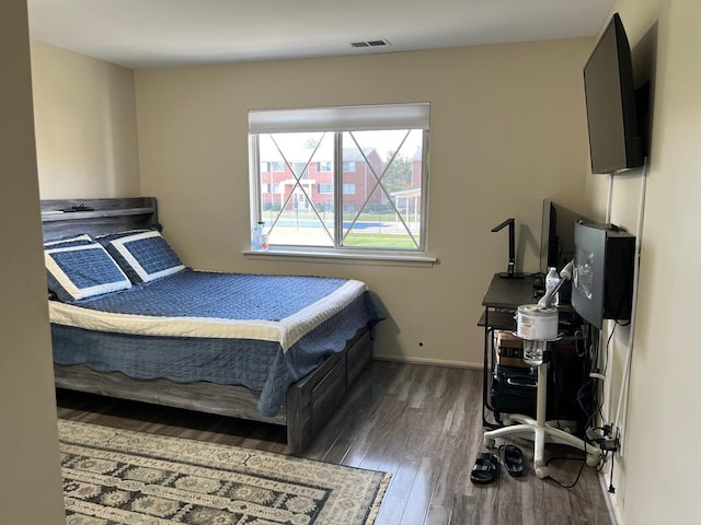 bedroom with dark wood-type flooring