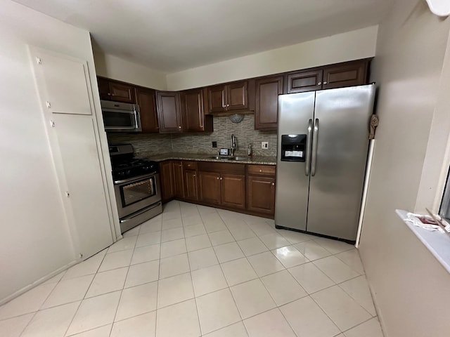 kitchen with sink, dark brown cabinets, and appliances with stainless steel finishes