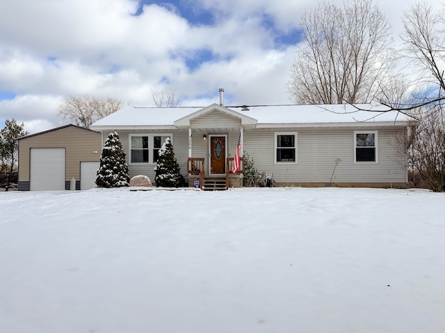 view of front of house featuring a garage and an outdoor structure