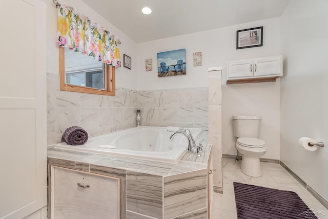 bathroom with tiled tub and toilet