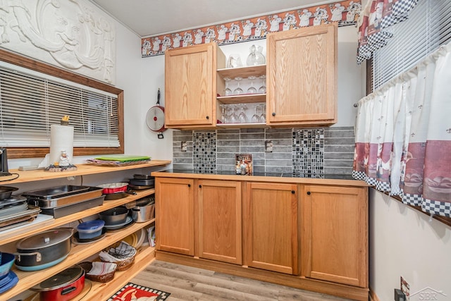 kitchen featuring light hardwood / wood-style floors and tasteful backsplash