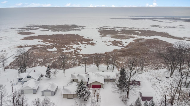 snowy aerial view with a water view