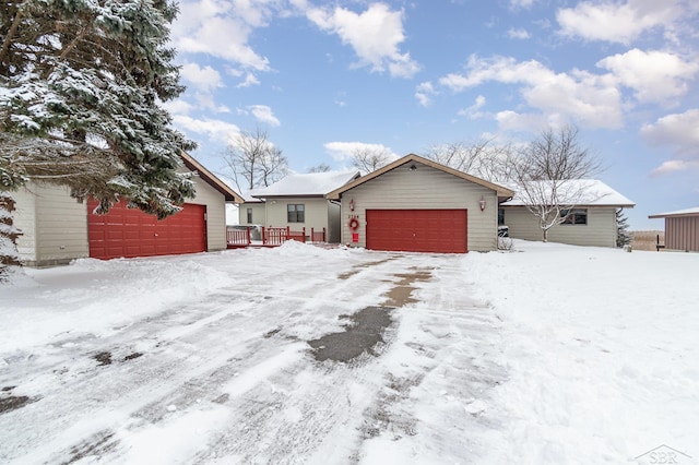 ranch-style house featuring a garage and an outbuilding