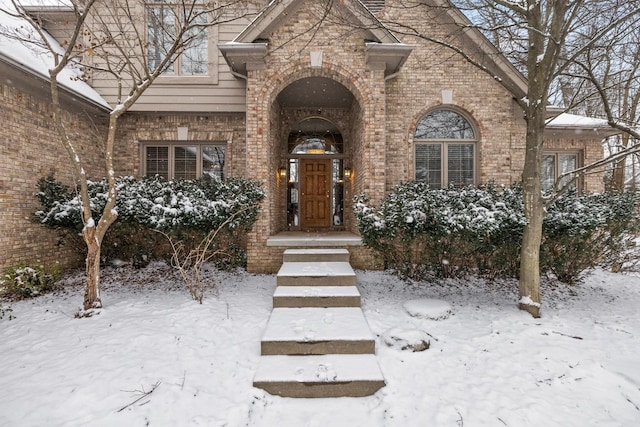 view of snow covered property entrance