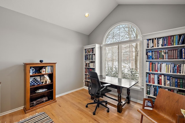 office featuring lofted ceiling and light wood-type flooring