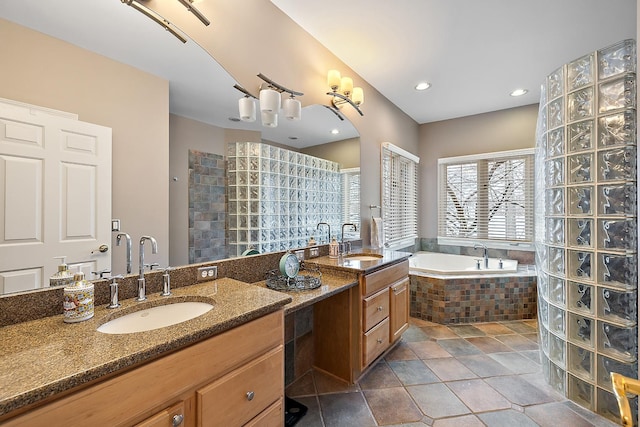 bathroom featuring vanity and tiled tub