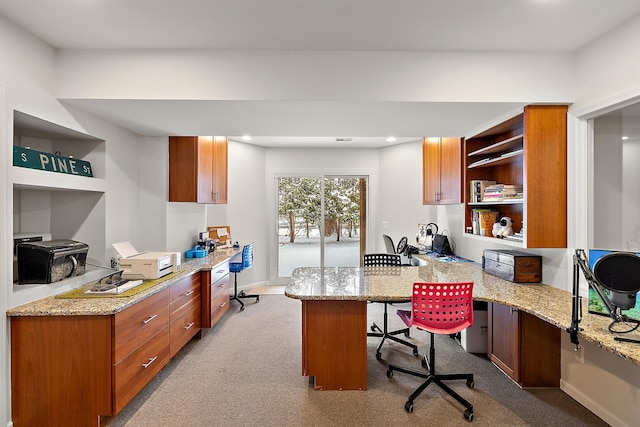 office with light colored carpet and built in desk