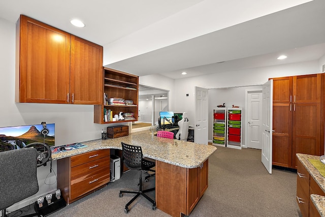 office space with light colored carpet and built in desk