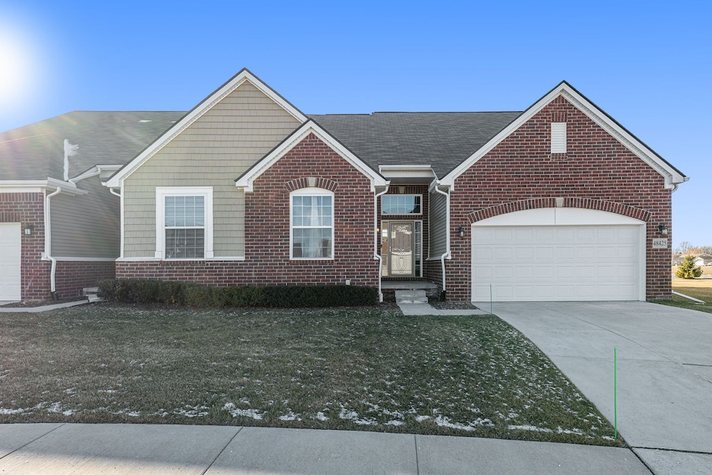 view of front of property with a garage and a front yard