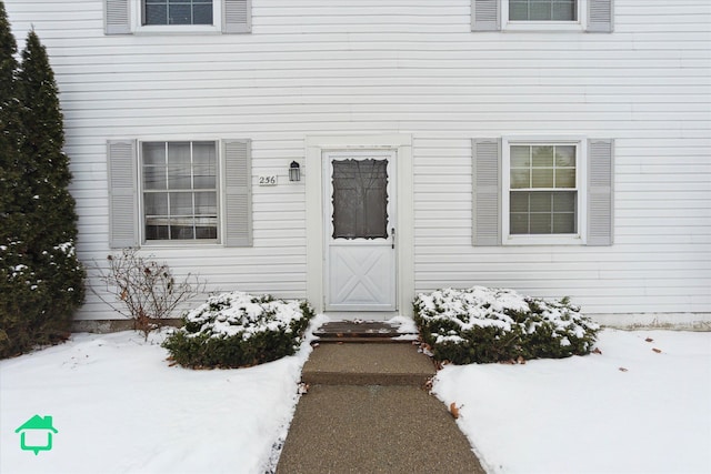 view of snow covered property entrance