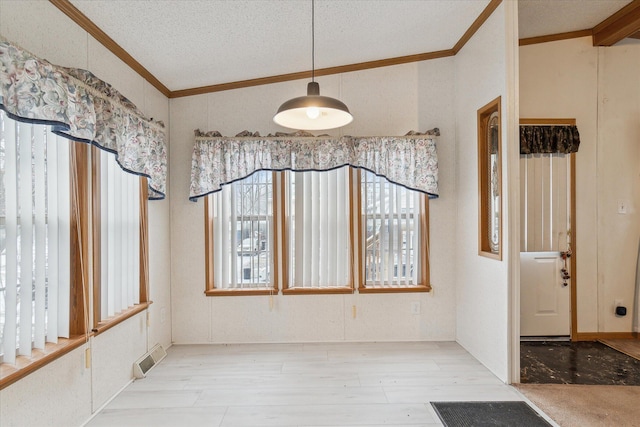 dining area with crown molding and a textured ceiling