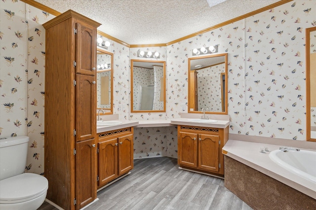 full bathroom featuring crown molding, hardwood / wood-style floors, a textured ceiling, toilet, and vanity