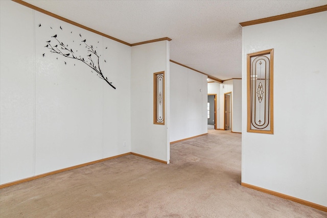 empty room with light colored carpet, a textured ceiling, and ornamental molding