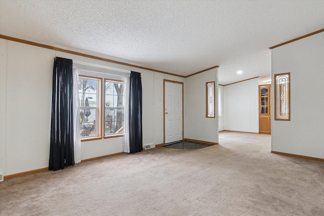 unfurnished room featuring a textured ceiling, light colored carpet, and crown molding