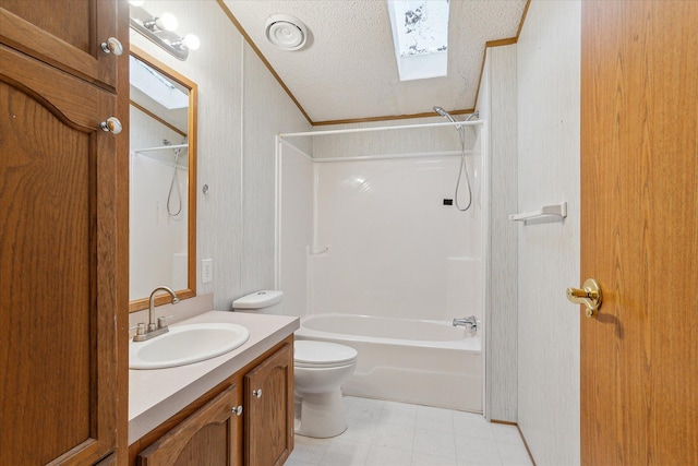 full bathroom with vanity, lofted ceiling with skylight, bathing tub / shower combination, toilet, and a textured ceiling