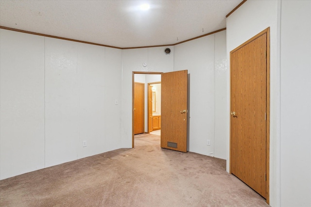 unfurnished room featuring light carpet and ornamental molding