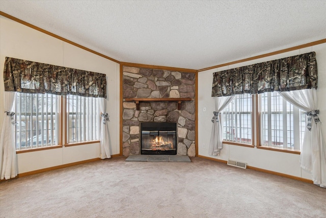 unfurnished living room featuring a fireplace, a textured ceiling, crown molding, and carpet flooring