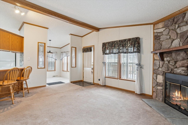 living room featuring light carpet, a healthy amount of sunlight, a stone fireplace, and lofted ceiling