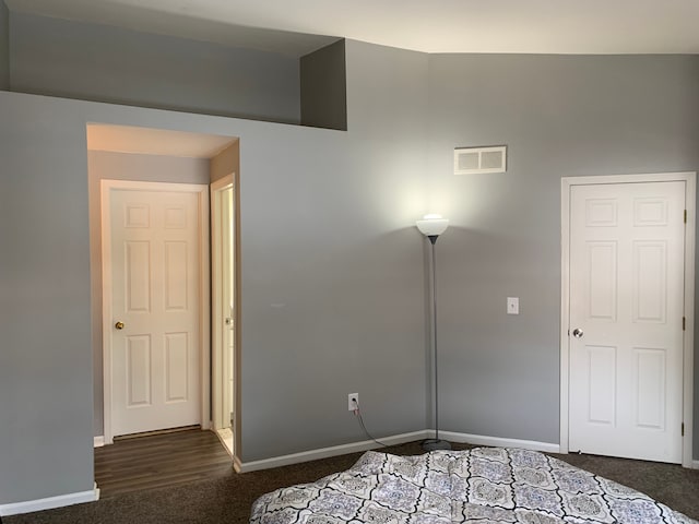 unfurnished bedroom featuring baseboards, visible vents, and carpet floors