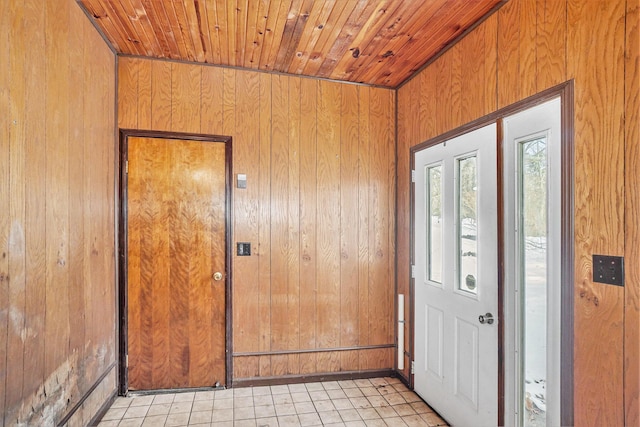 foyer featuring wood ceiling and wooden walls