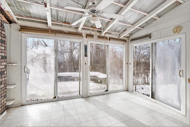 unfurnished sunroom with lofted ceiling, a healthy amount of sunlight, and ceiling fan