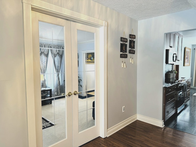 interior space featuring french doors, a textured ceiling, and dark wood-type flooring