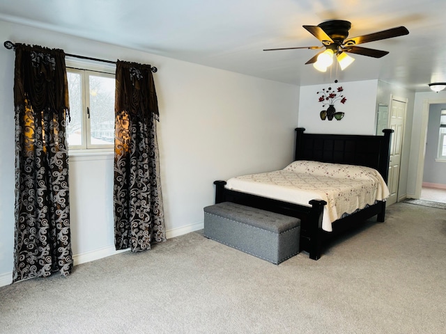 carpeted bedroom with a closet and ceiling fan