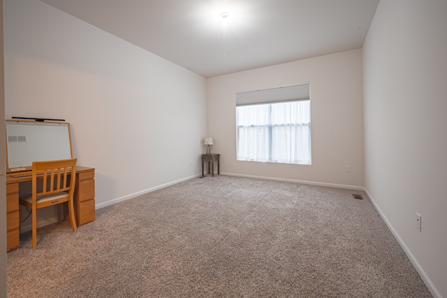 spare room featuring carpet