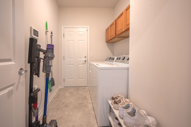 laundry room featuring cabinets and washing machine and clothes dryer