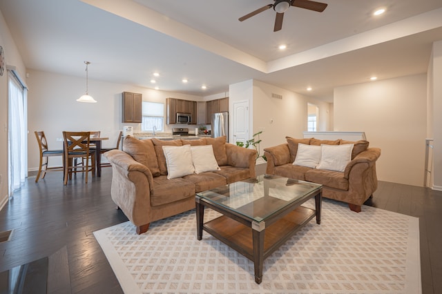 living room with ceiling fan, light wood-type flooring, and sink