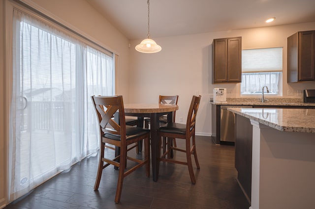 dining space with a healthy amount of sunlight, sink, and dark wood-type flooring