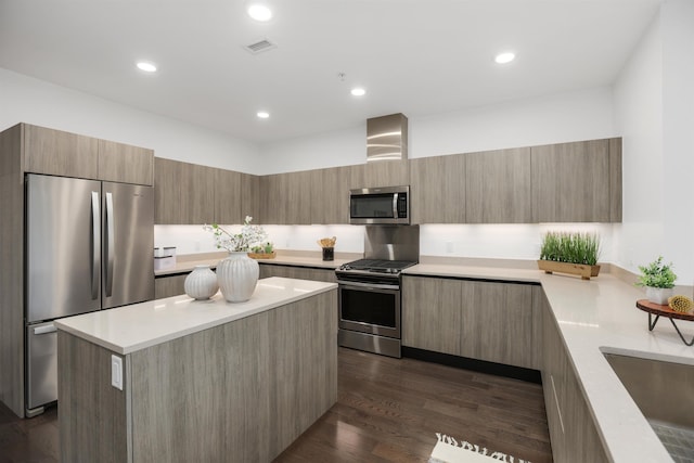 kitchen featuring sink, a kitchen island, dark hardwood / wood-style flooring, and stainless steel appliances