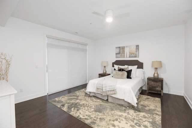 bedroom with ceiling fan, dark hardwood / wood-style floors, and a closet