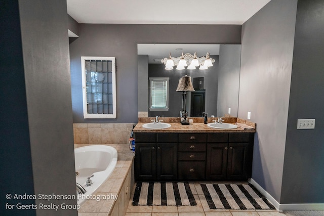 full bathroom featuring a garden tub, double vanity, a sink, and tile patterned floors