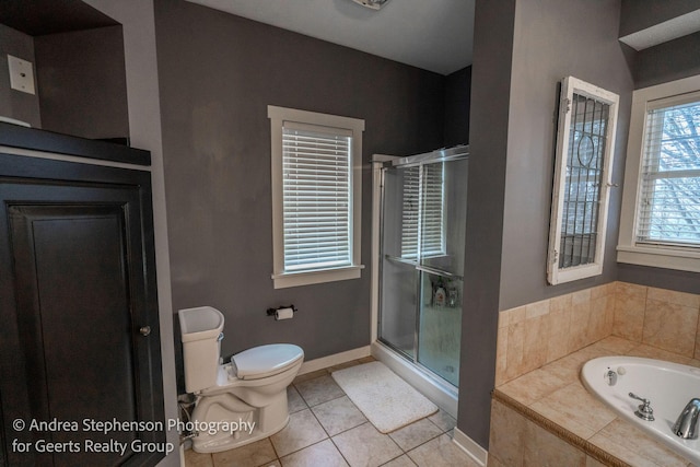 bathroom with a stall shower, baseboards, toilet, tile patterned floors, and a bath