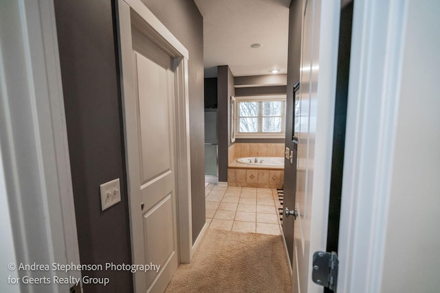 full bathroom featuring tile patterned flooring and a bath