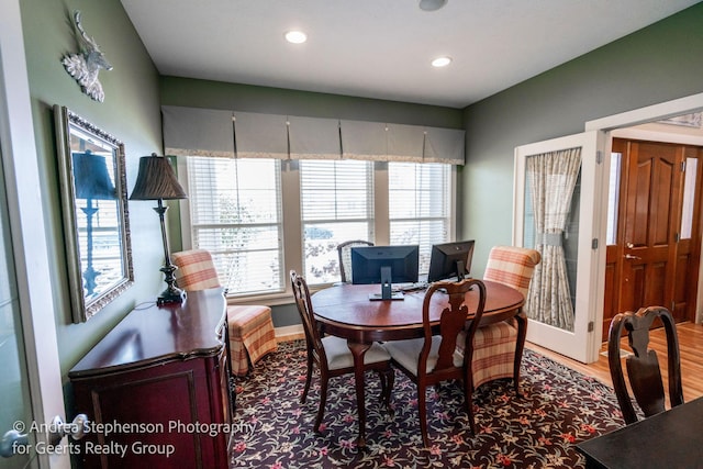 dining area featuring baseboards, wood finished floors, and recessed lighting