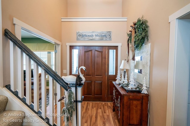 entrance foyer with light wood-style floors and stairs